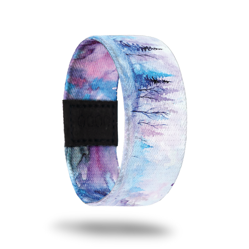 Be Still My Soul-Sold Out-ZOX - This item is sold out and will not be restocked. White snowy background with blue and pink pine trees in the background. Inside is blue, pink and purple watercolor and says Be Still My Soul. 