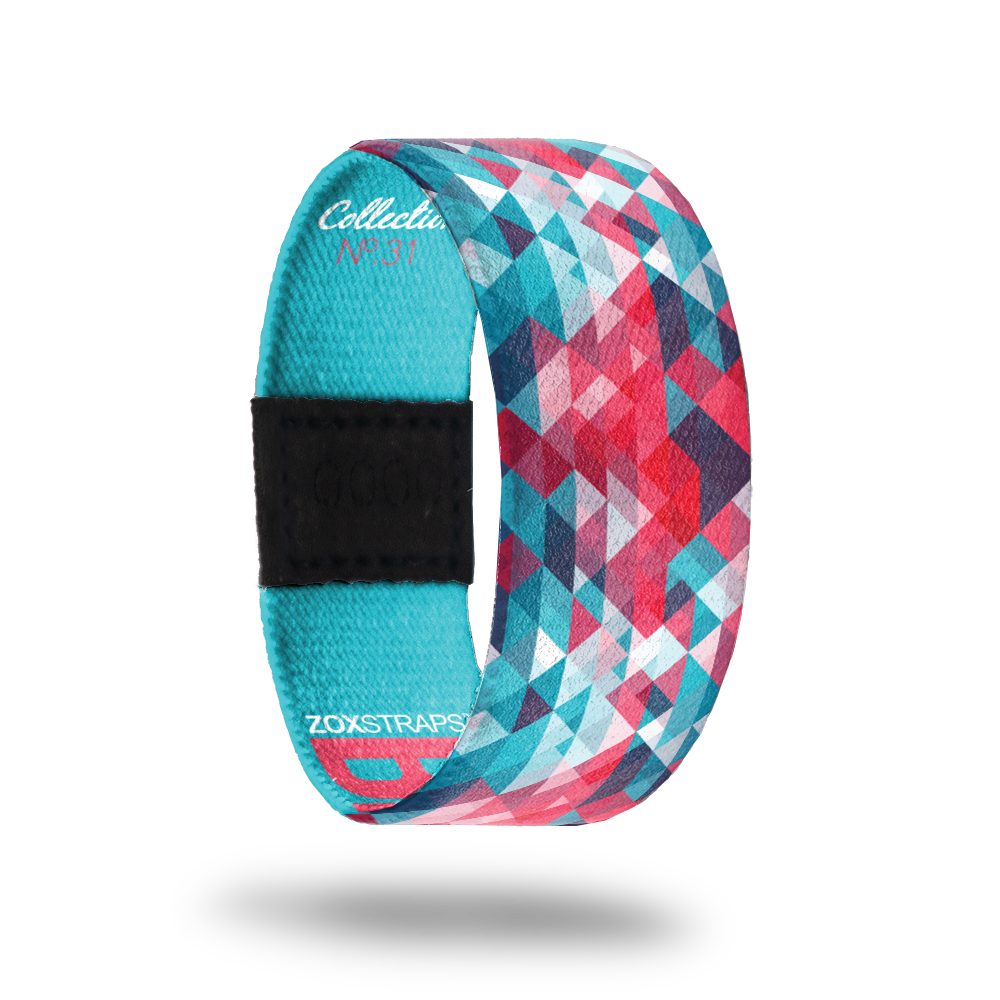 Brave.-Sold Out-ZOX - This item is sold out and will not be restocked. Various teal, red, blue and white tiny triangles to form an abstract effect. Inside is solid teal and reads BRAVE in red. 