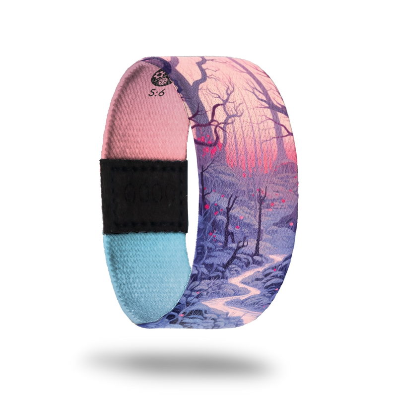 Strap is a forest scene at twilight with a river running through, dormant trees and a pink glow of the sun. Inside is pink and blue gradient and says Comfort In The Quiet. 