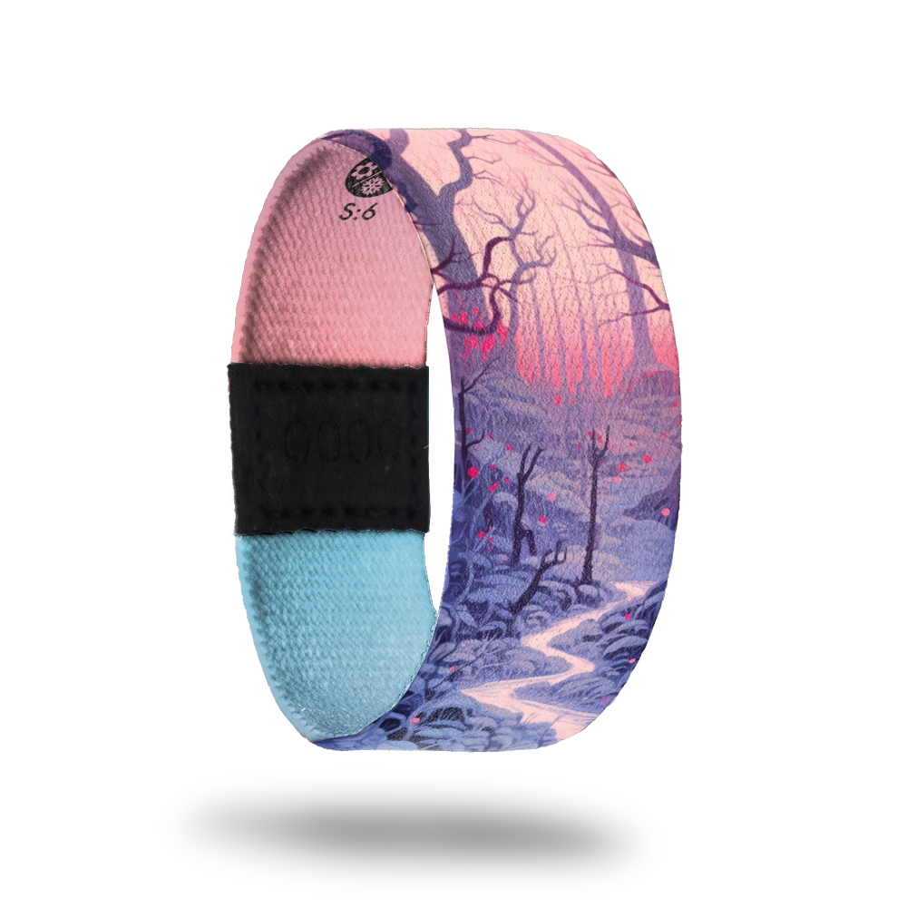 Strap is a forest scene at twilight with a river running through, dormant trees and a pink glow of the sun. Inside is pink and blue gradient and says Comfort In The Quiet. 