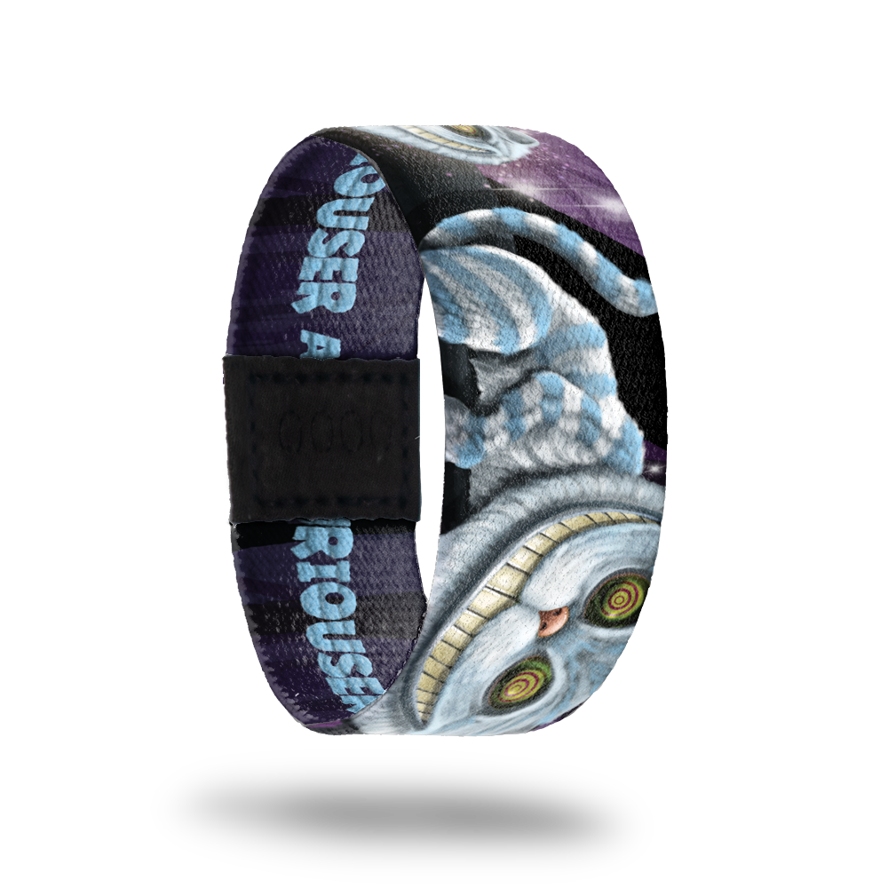 Outside Design of Curiouser: dark purple sky with blue and white Chesire cat throughout the strap