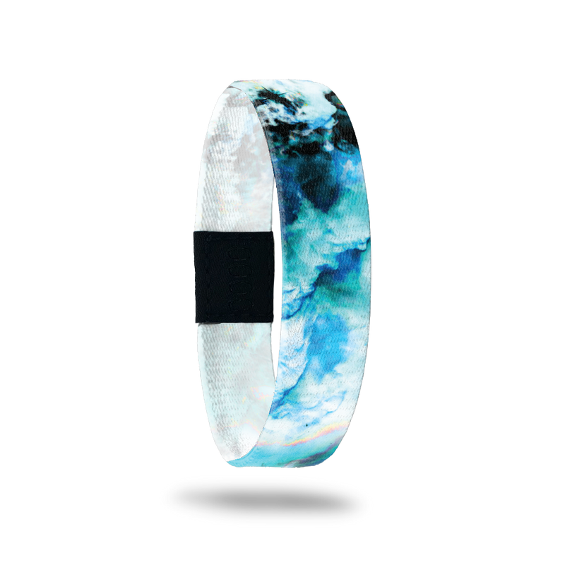Wristband with a blue, teal, black and white marble design. Inside reads Focus On The Positive. 