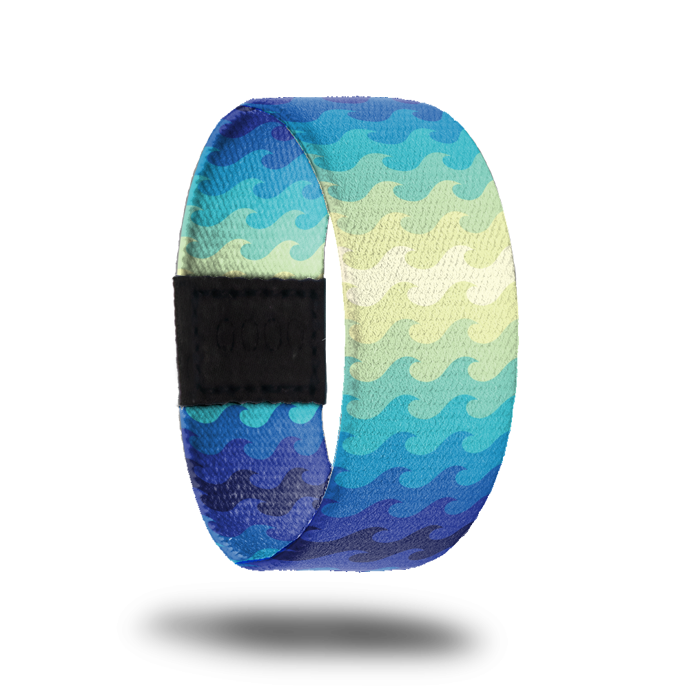 Outside design of Go With The Flow. Simple drawn wave pattern with gradient colors of dark blue to light blue to pale yellow back to light blue to dark blue.