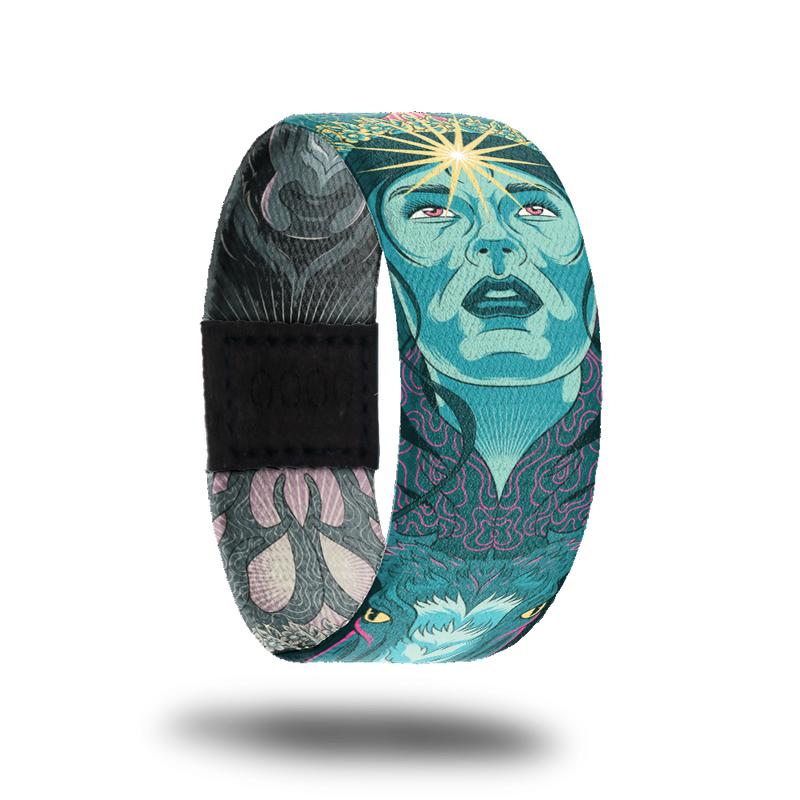 product image of a wristband named Inner Light showing the outside design. The design is hues of blues and greens showing a hand drawn face with a shining star on the person's forehead 