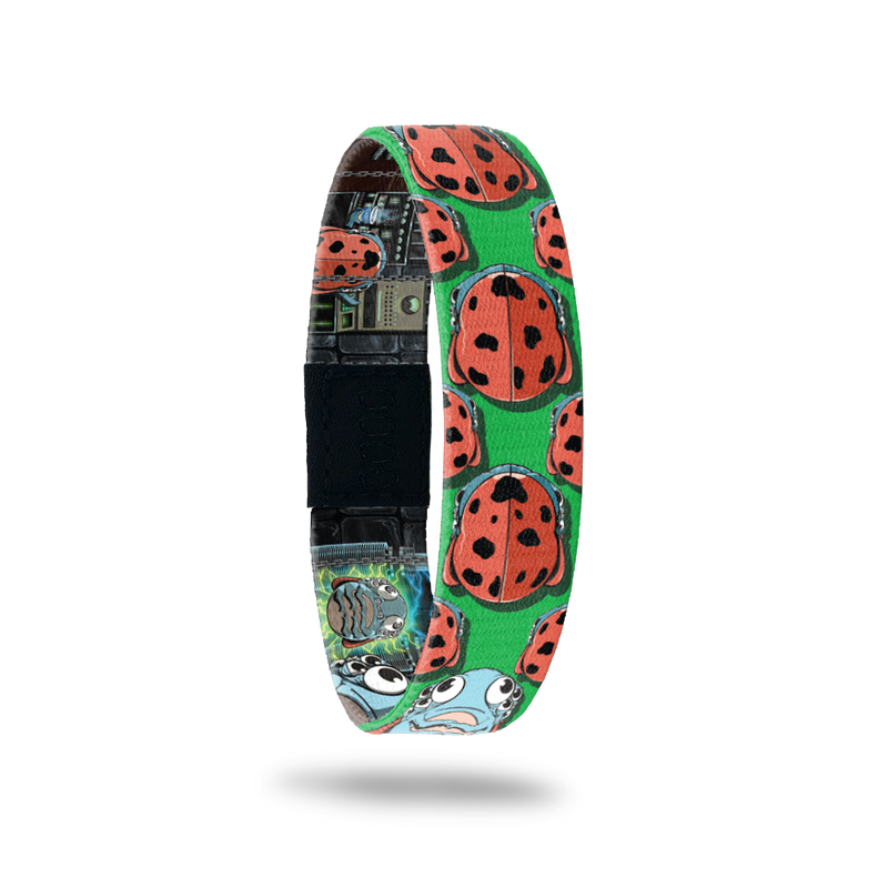Green bracelet with prints of ladybugs all over. Comes with a matching pin of a monster ladybug that looks scared. 