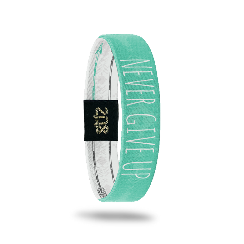 Inside Design of Never Give Up: turquoise and light turquoise tribal design with white text overlaying ‘Never Give Up’