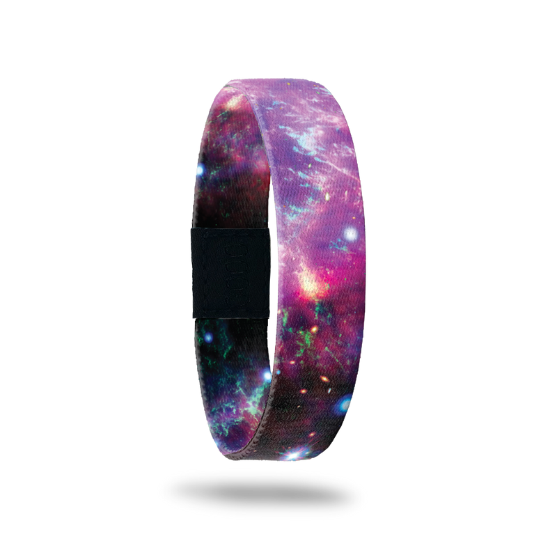 Wristband single with a purple and black Nebula design with hints of blue and pink. Inside is the same and says One Step At A Time. 