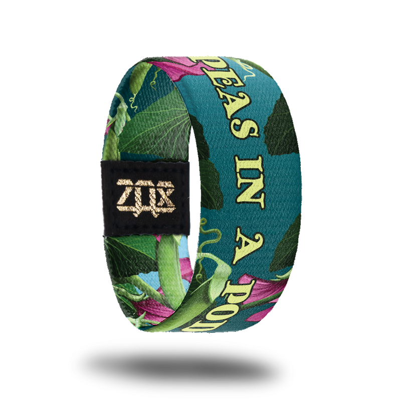 Inside design for Peas In A Pod. Dark teal background with a few pink flowers and green plant life. Centered is Peas In A Pod in yellow-green text 