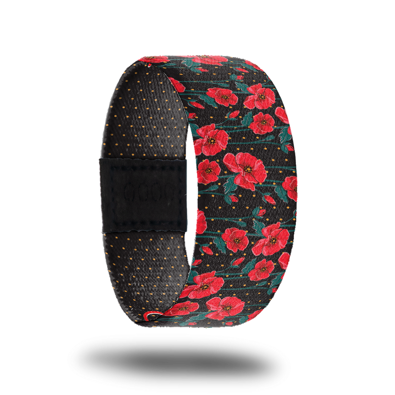 Outside design for Self Love. Black background with small red dot patteren and on top red flowers with small green leaves