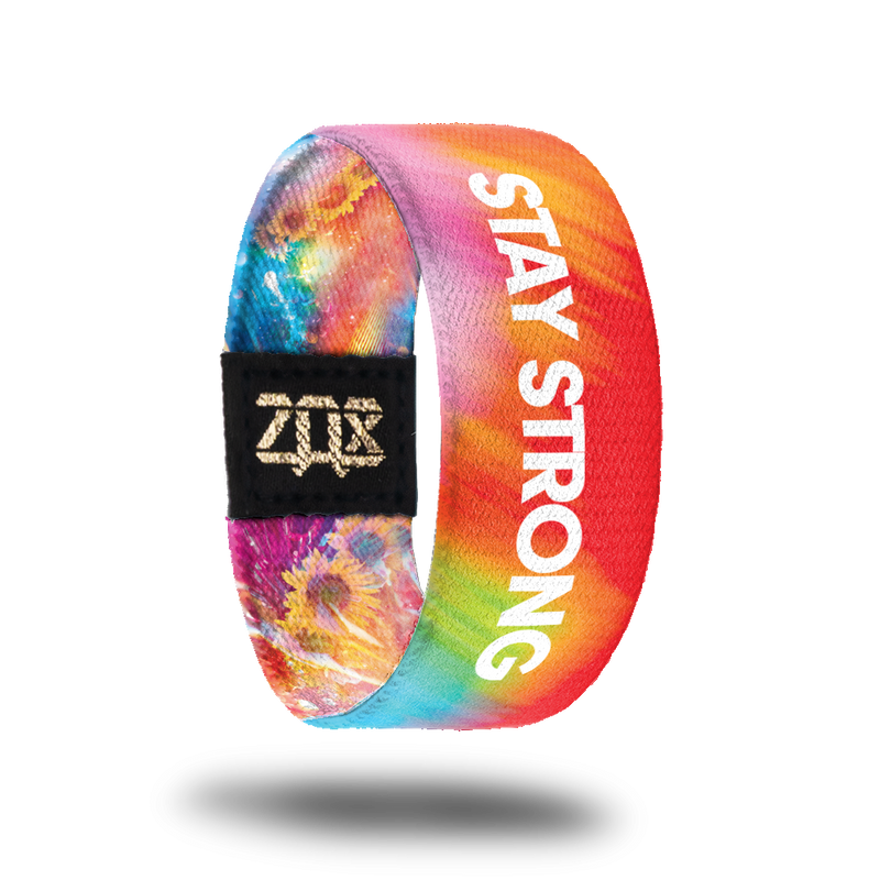 Inside design for Stay Strong. Blended background with red, light orange, a little green, and a little blue. Stay Strong is centered in white text