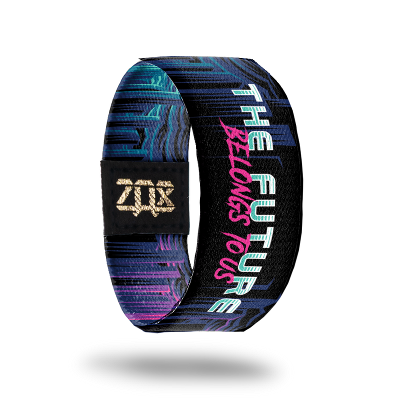 Inside Product image of elastic wristband called The Future Belongs To Us. The design is name of the wristband in a blue and pink font with a light blue and pink background on the sides with darker colors in the middle and behind the font.