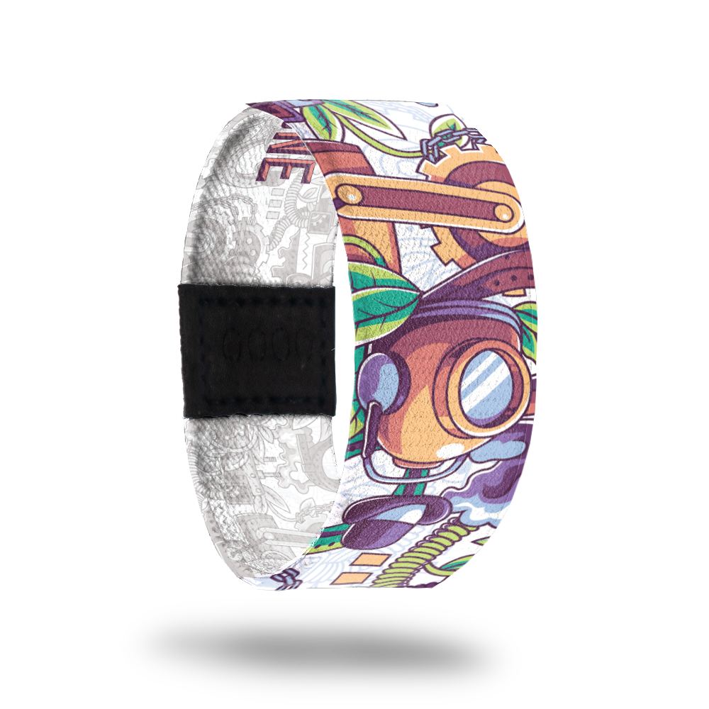 Outside design of elastic wristband called There Can Only Be One. The design is a bunch of random items such as a helmet, a plant, gears, a hat, coils and other items. The colors are mainly orange, green, and purple