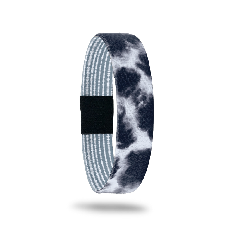 Wristband single with a greyish blue and white cloud design. The inside is pale blue and white stripes and reads Quiet Your Mind. 