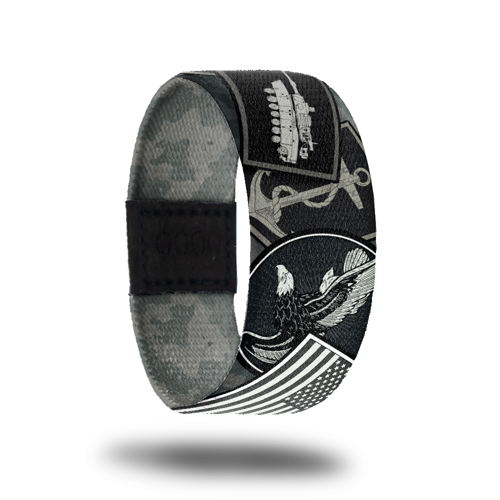 product photo of the outside design of a wristband made for Veterans, the design features various symbols used for branches of the military