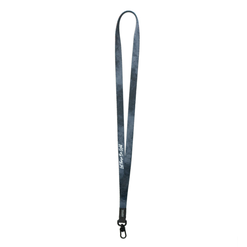 A product image of a ZOX lanyard showing the back of the design with a black colored metal clip. The lanyard is called and says Let There Be Light and the design is a grayscale version of the front design which is a space nebula 