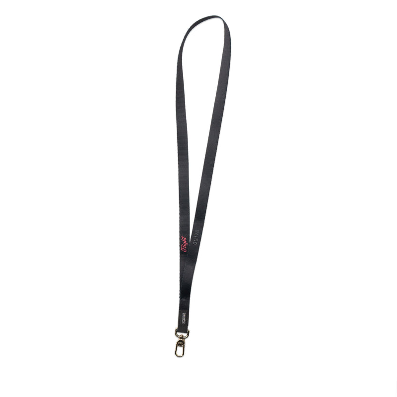 A product image of a ZOX lanyard showing the back of the design with a gold colored metal clip. The lanyard is called Flight and the design is a grayscale version of the front design which is a space nebula