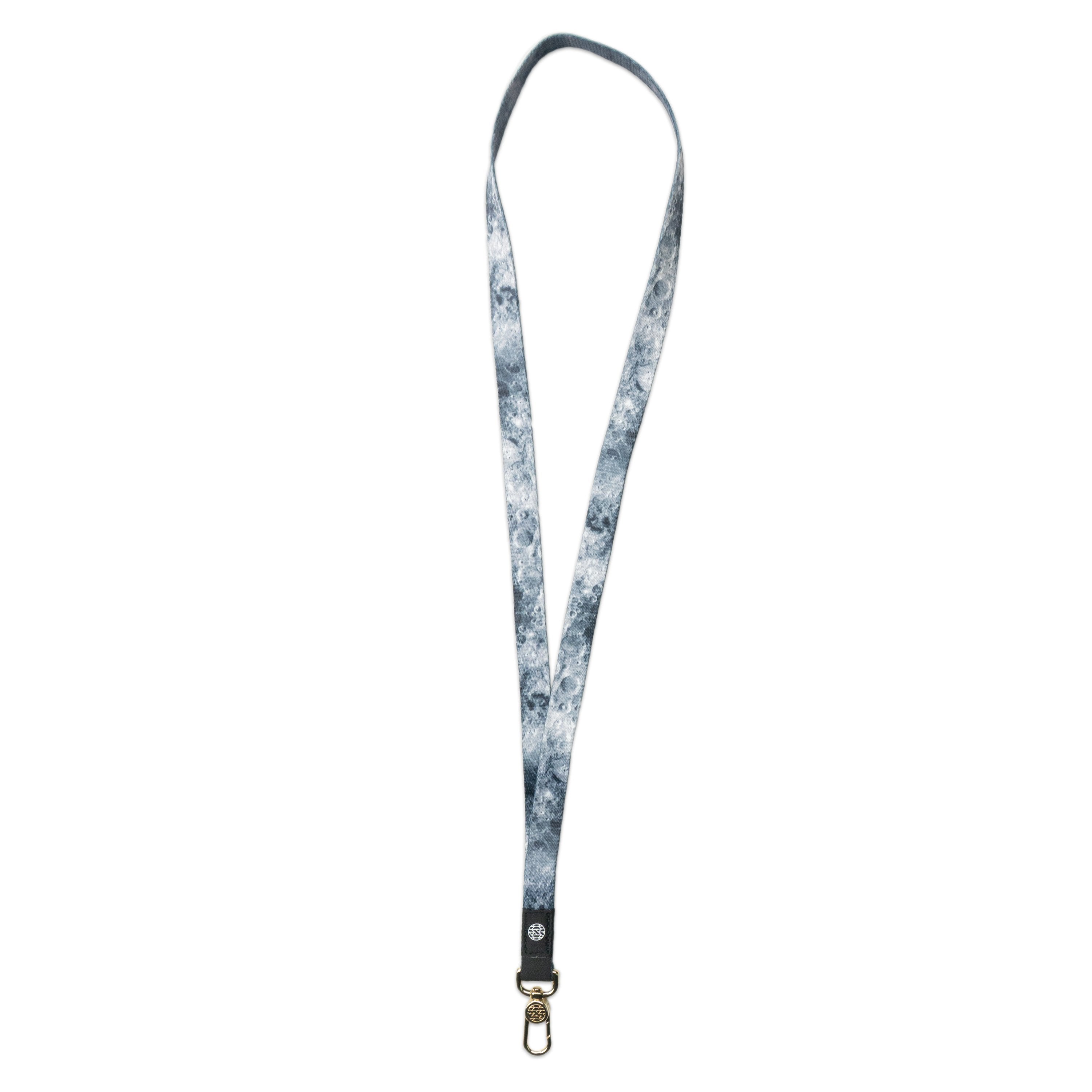 A product image of a ZOX lanyard showing the front of the design with a gold colored metal clip. The lanyard is called Moon and the design is an image of the moon's surface that is mainly grey and black