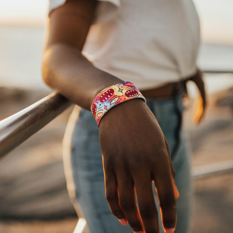 Lifestyle image of arm resting on a railing wearing True To You