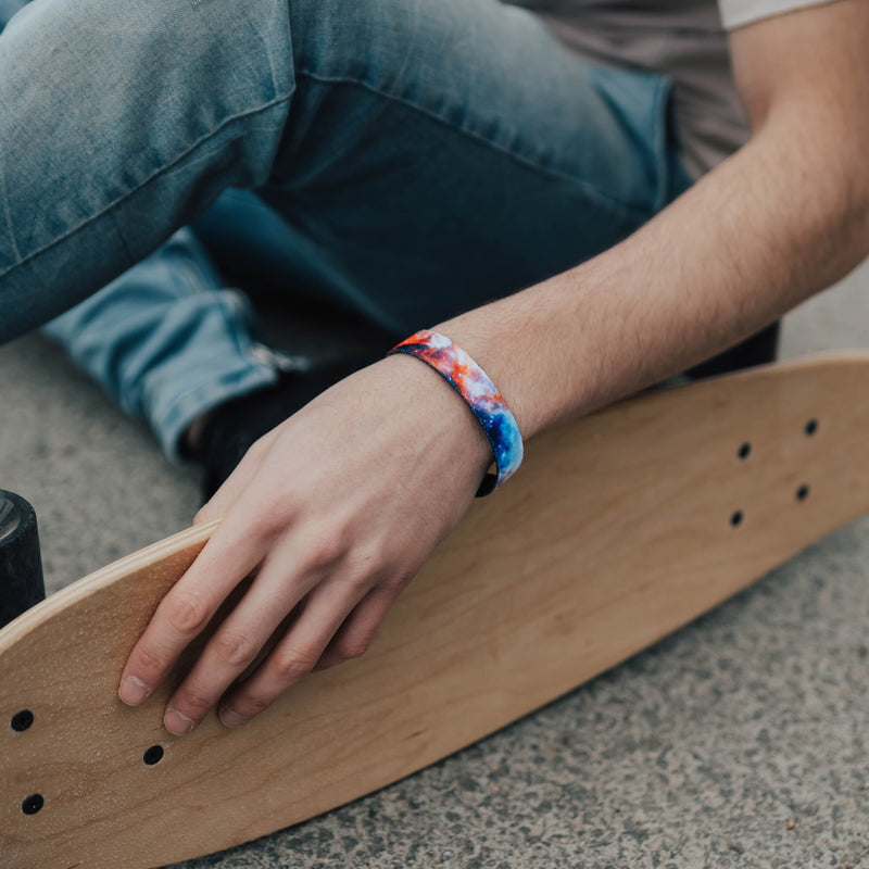 Lifestyle image of someone resting their hand on a skateboard and wearing Let There Be Light