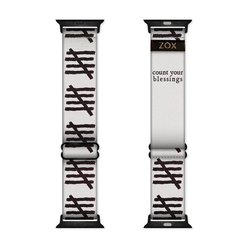 This is a watchband and not reversible. The base color is off-white/light grey. It has tally marks all down the sides of the bands. The inside is the same design and reads Count Your Blessings. 