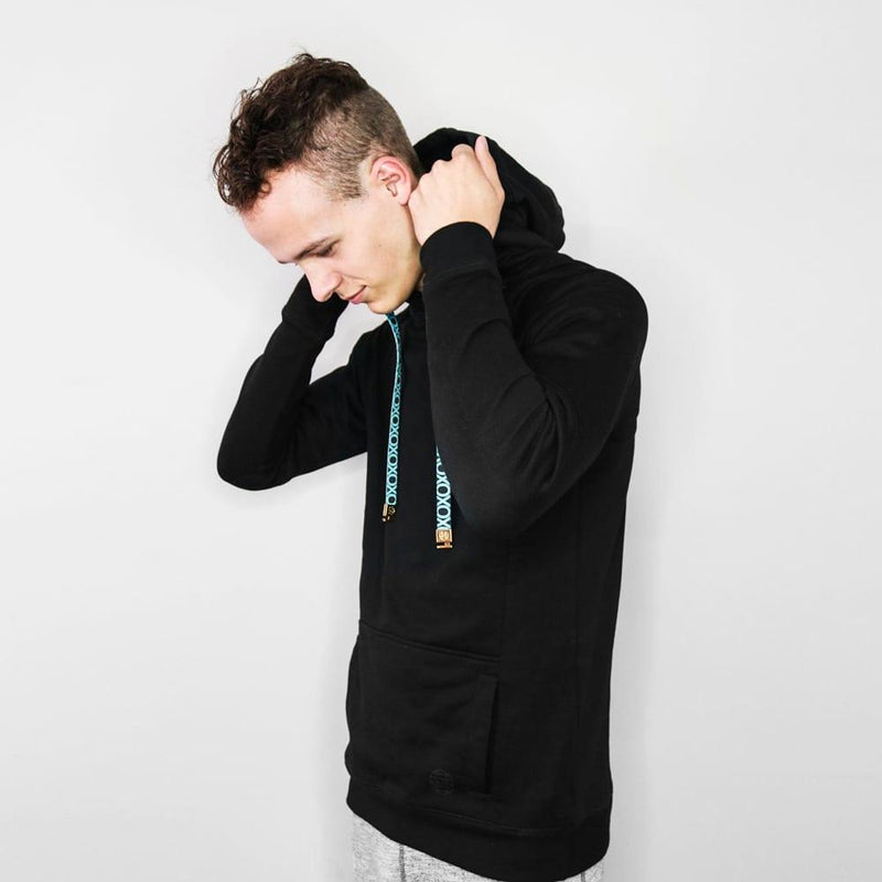 a side photo of a young adult male wearing a black Imperial hoodie putting the hood on. You can see he has changed the string to be a different design