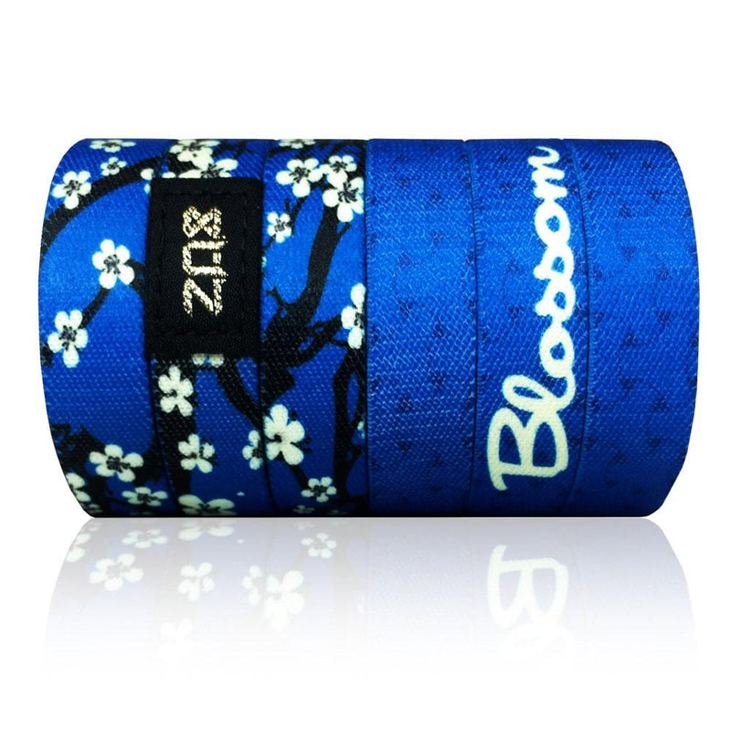 Bright blue base with white cherry blossoms all over. Inside is solid blue and reads Blossom. This is a headband, not a wristband. 