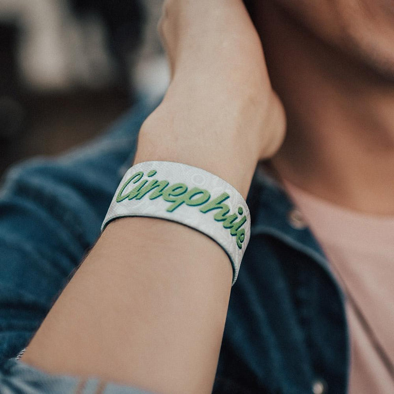 Lifestyle image close up of Cinephile on someone's wrist with the words Cinephile showing in green