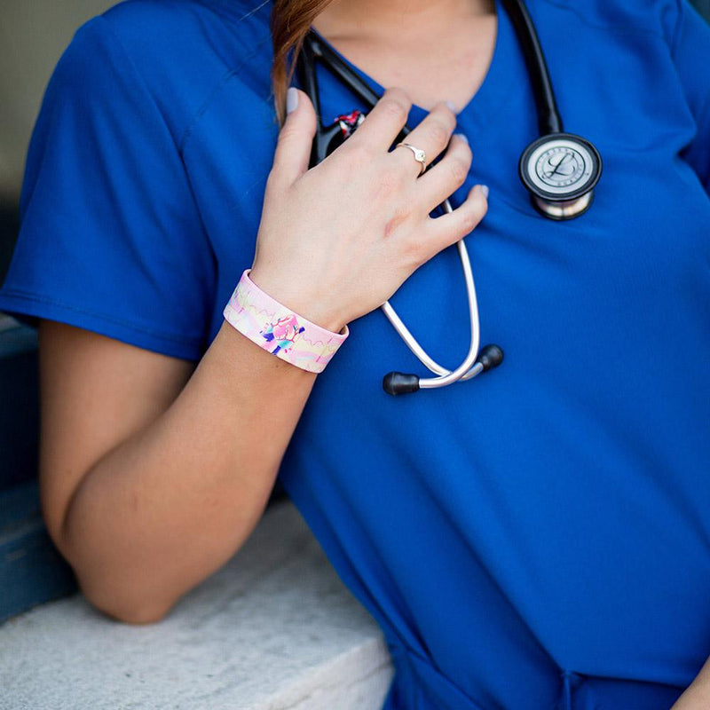 Lifestyle photo of a nurse wearing Can't Stop The Beat strap.