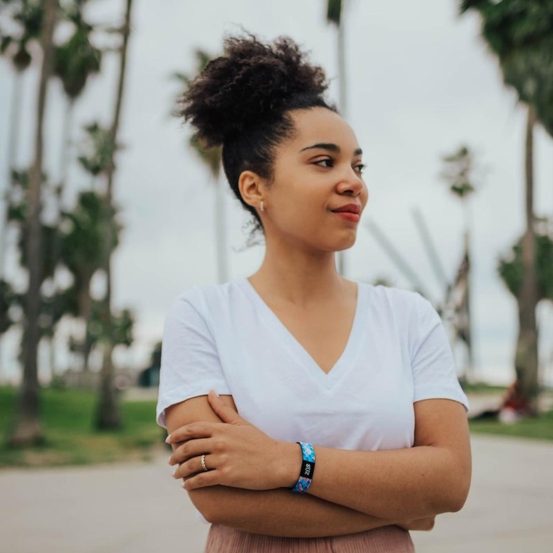 Lifestyle photo of girl wearing do my best single showing the outside design with fish scales of a variety of scales of blue, coral, and purple gradient coloration with ZOX logo facing out