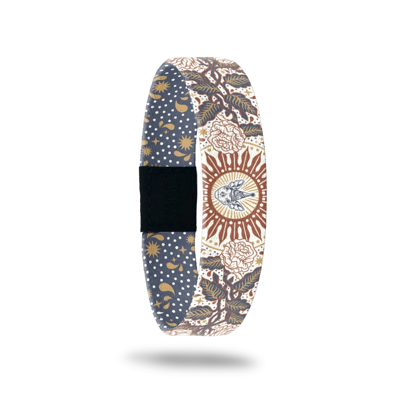 ZOX single with a design of rose vines. In the center is a sunburst with a drawing of Kirby, Jason's deceased dog, wearing a birthday hat that says You're Awesome. The colors are white, muted green and burnt orange. The inside is navy and gold starbusrts and reads Dream Bigger. 