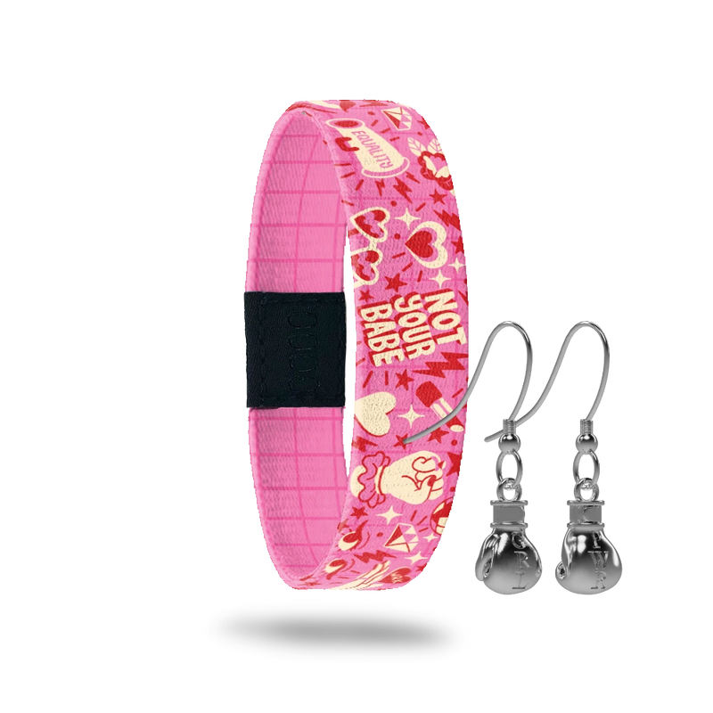Wristband with pink base and red and offwhite "girl power" phrases and hearts. Inside is a pink base with red pinstripes and reads Fight Like A Girl. Comes with a matching pair of stainless steel boxing glove earrings. 