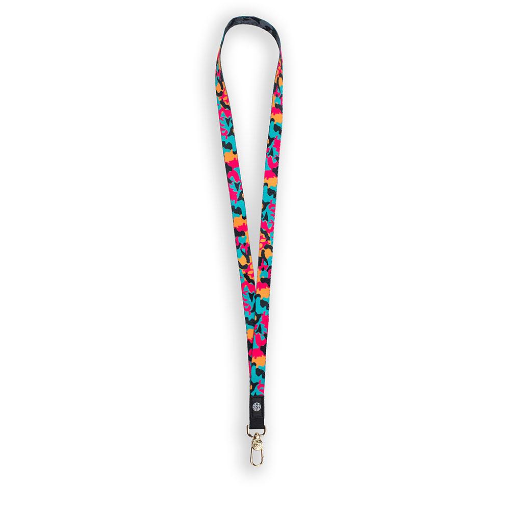 A product image of a ZOX lanyard showing the front of the design with a gold colored metal clip. The lanyard is called Fearless and the design is a modern camo that is black, orange, pink and blue 