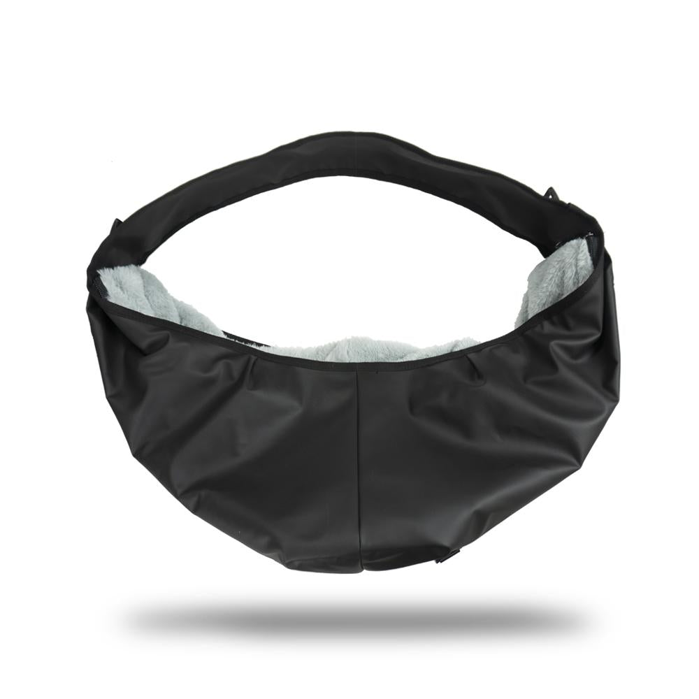product image showing the side of a black dog carrier with fur lined inside. 
