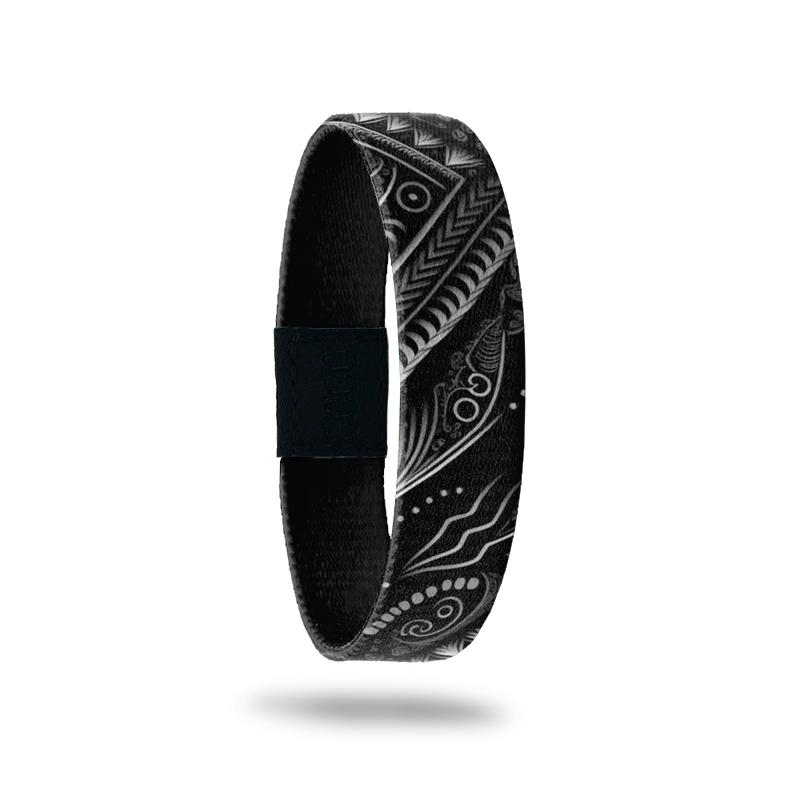 Wristband is black with white geometric and abstract designs. Inside is sold black and reads Get It Done. 