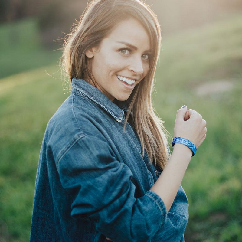 Lifestyle image close up of someone smiling with Give Thanks on their wrist 