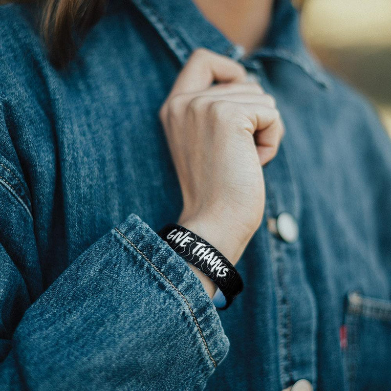 Lifestyle image close up of Give Thanks on model's wrist