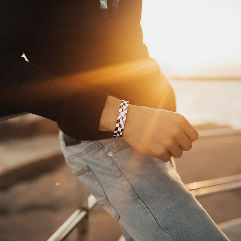 Lifestyle image of someone leaning against a rail and wearing Hustle