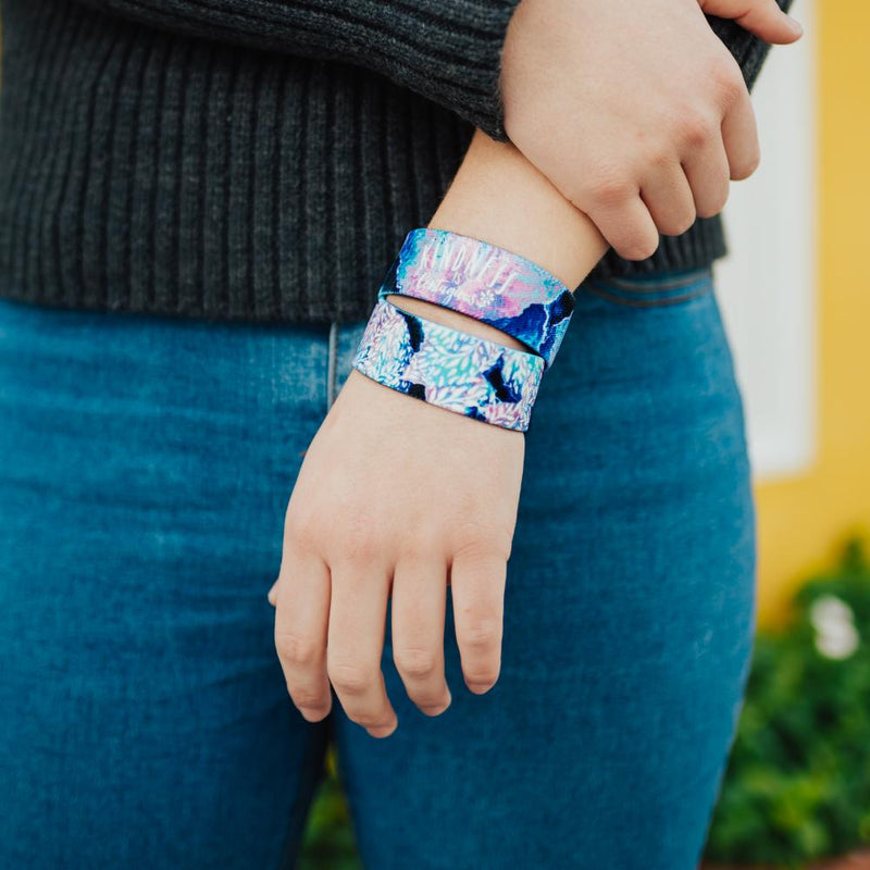 Lifestyle close up image of model's wrist wearing 2 Kindness Is Contagious straps