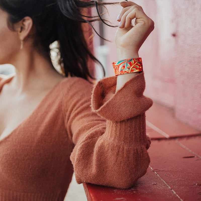 Lifestyle image of arm resting on wooden ledge with Life Is A Gift on their wrist