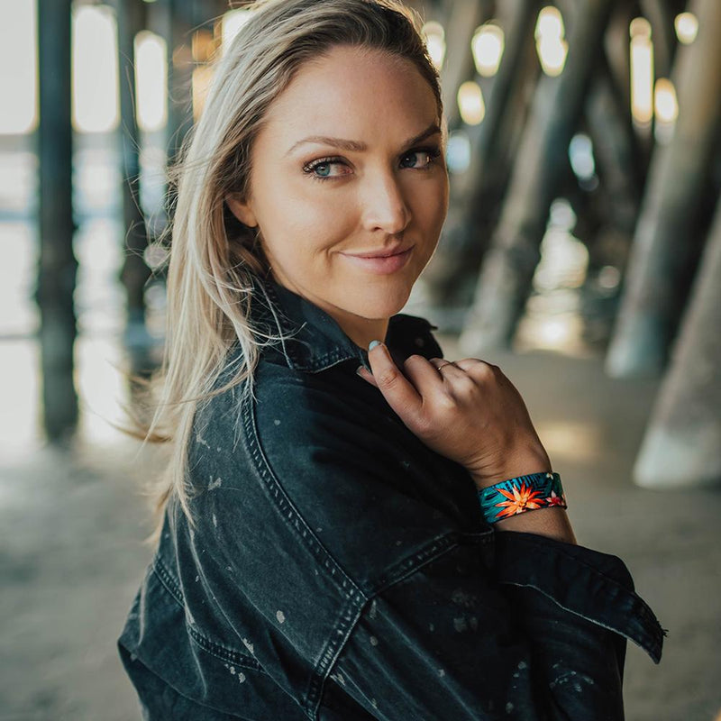 Lifestyle image of a women under a beach pier wearing Make It Happen