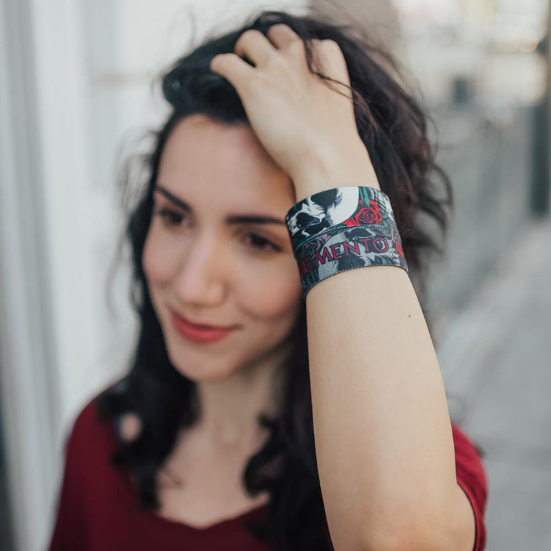 Lifestyle close up image go model fixing their hair and wearing two Memento Mori straps