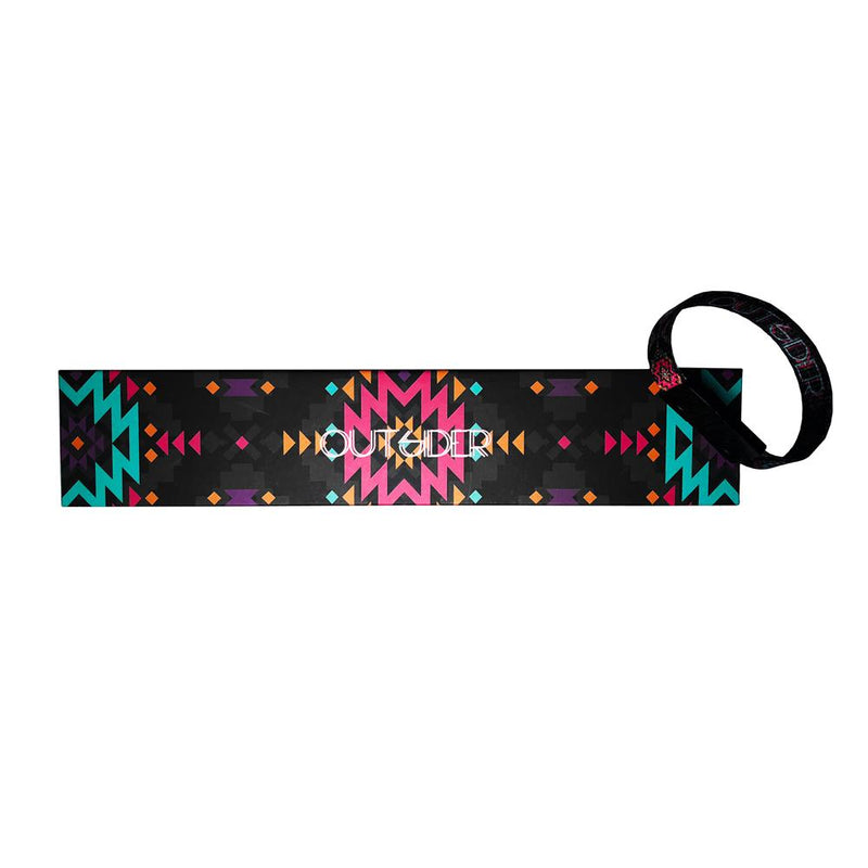  Studio image of Outsider clasped together laying on the box it comes in, which has a design of a black background with geometric shapes in pink and teal and Outsider centered in white text.