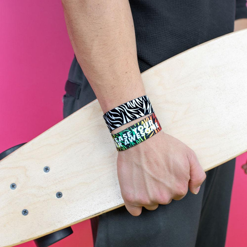 Studio image of model holding a skate board and wearing 2 Release Your Inner Awesome