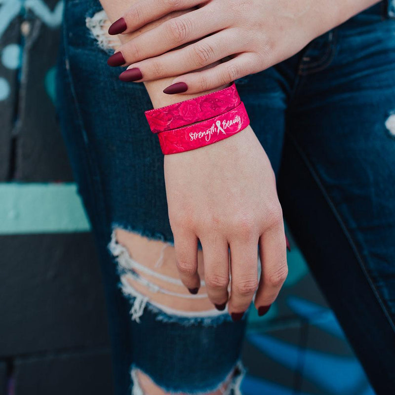 Lifestyle image close up of 2 Strength and Beauty on model's wrist