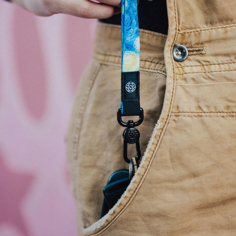Lifestyle image of Starry Night lanyard being pulled from a pocket and clipped to keys