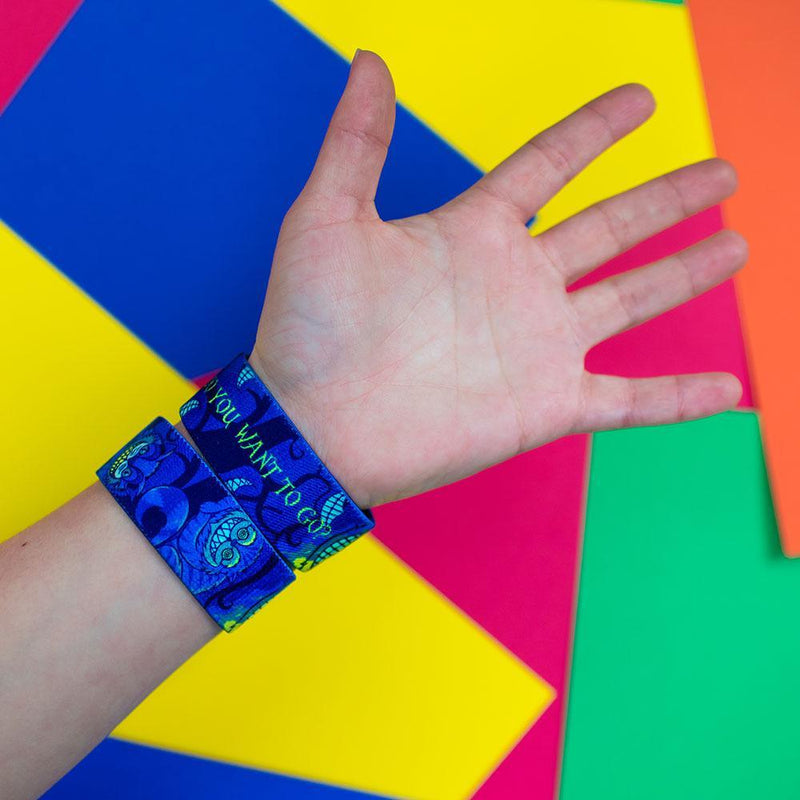 Studio Image of hand in front of a color background wearing 2 Where Do You Want To Go?