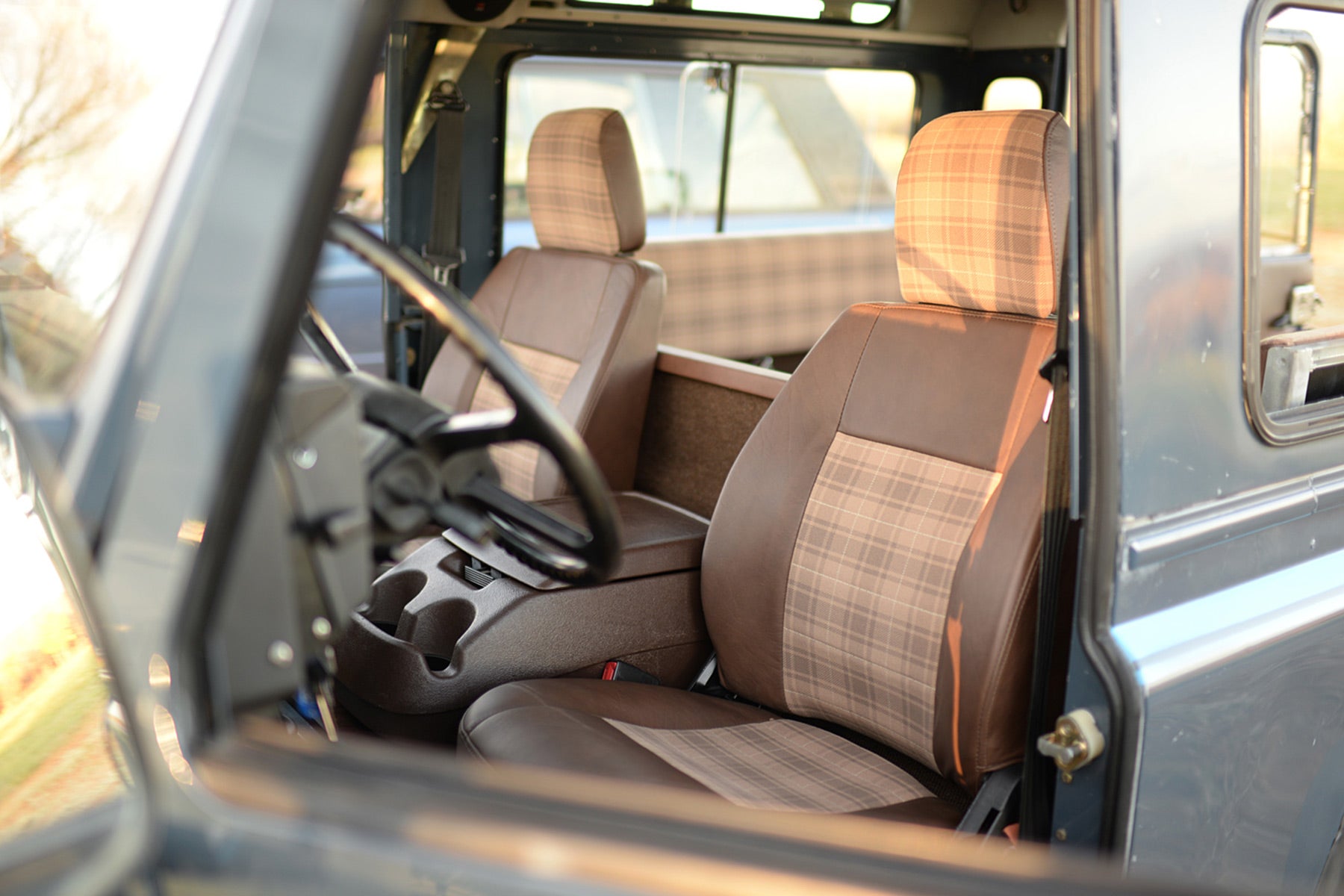 Relicate Leather Land Rover Defender interior with plaid cloth inserts