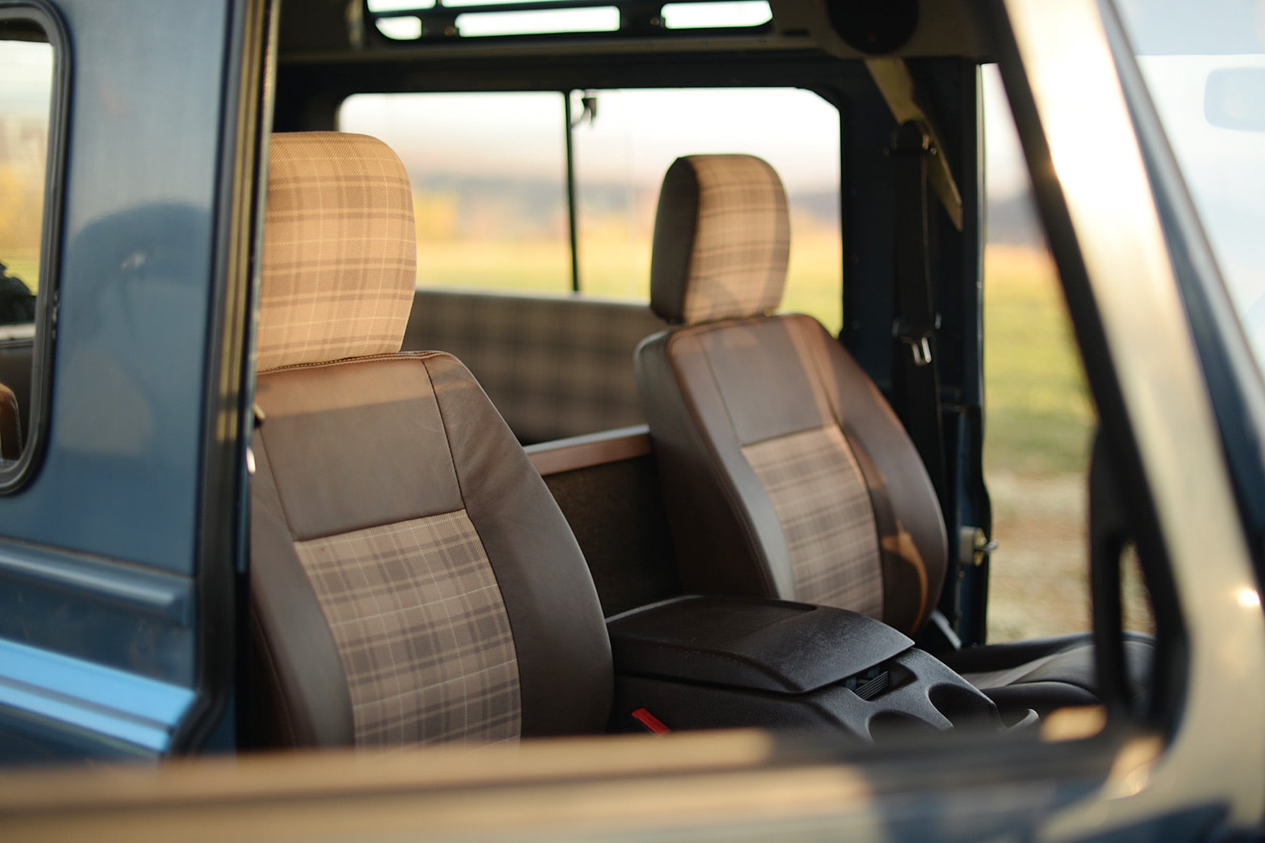 Relicate Leather Land Rover Defender interior with plaid cloth inserts