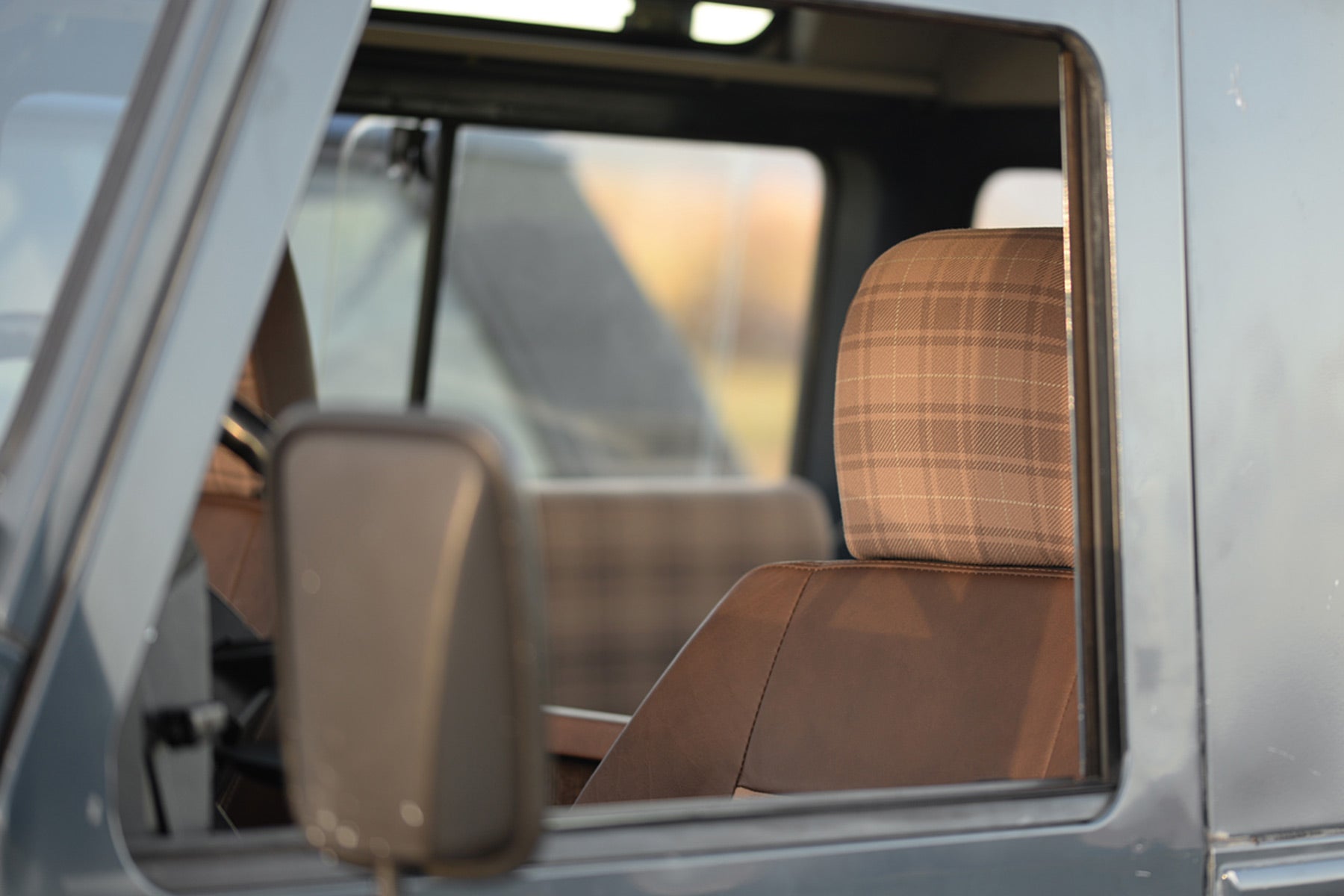 Relicate Leather Land Rover Defender interior with plaid cloth inserts