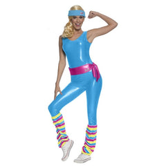 female appearing person in athletic pose wearing a blue sleeveless jumpsuit with pink belt. There is a rainbow legwarmer look on the jumpsuit and a blue headband.